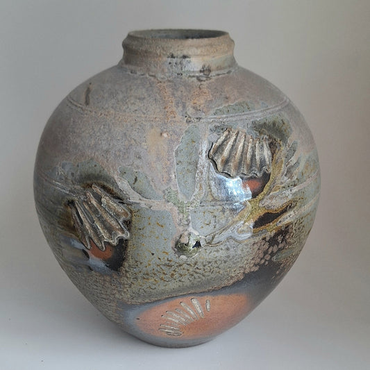 Wood fired jar with shell scars.